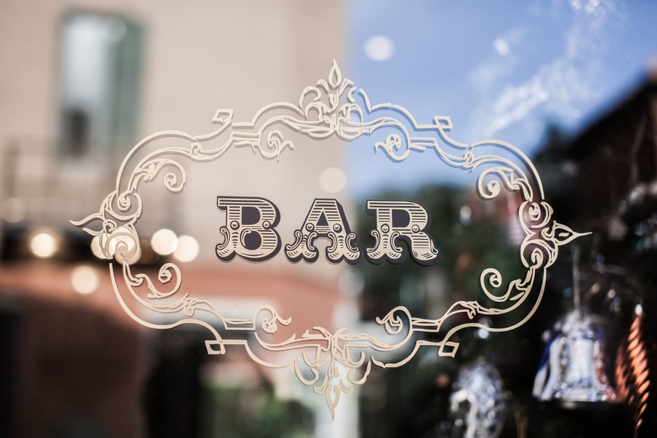 bar sign on glass door